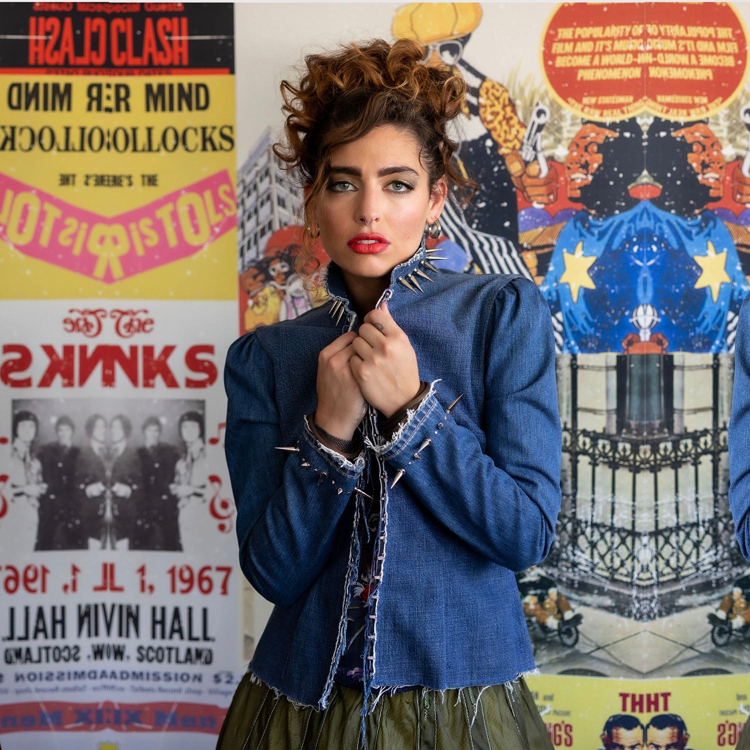 Elara jacket model in upcycled blue denim with nickel spikes, fitted glam punk jacket by Deborah Lindquist