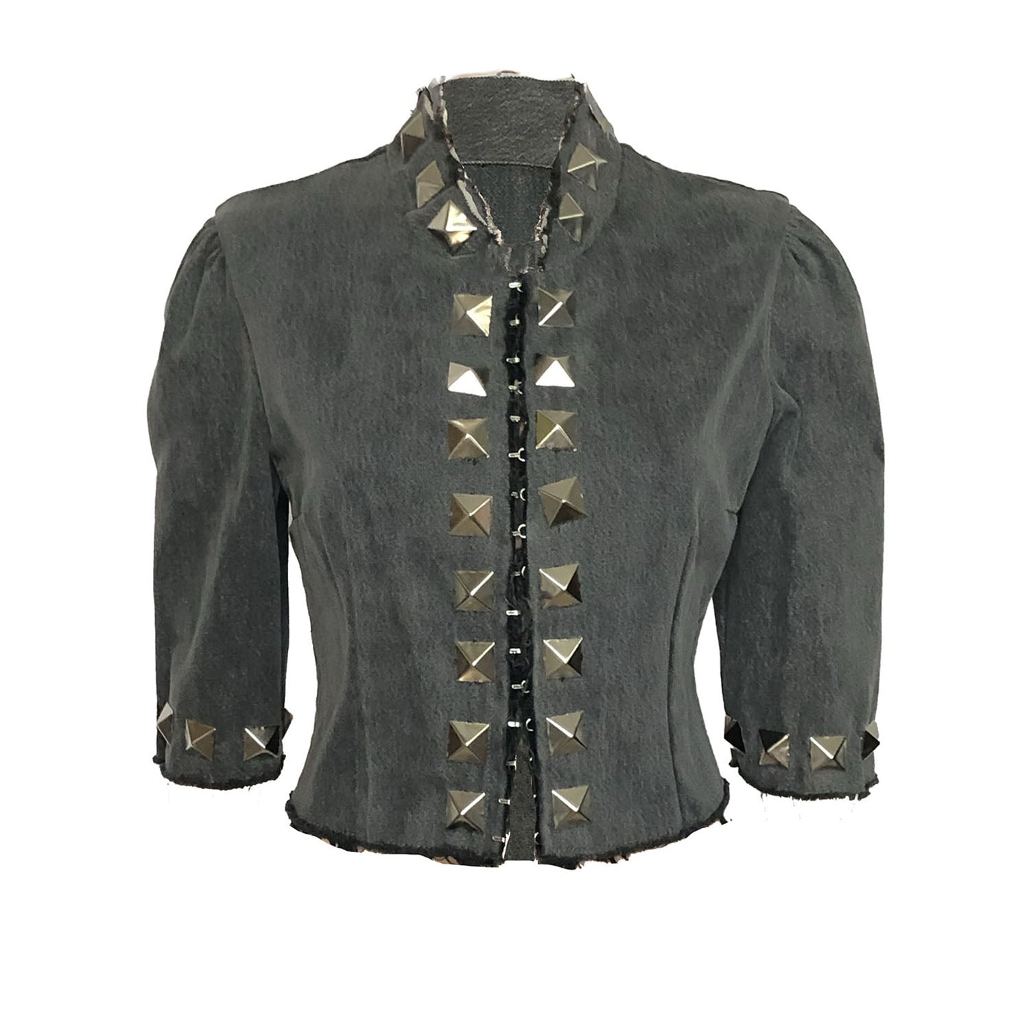 Patti Jacket in upcycled denim with silver studs on collar, cuffs, and front, mandarin collar, and raw edge detailing.