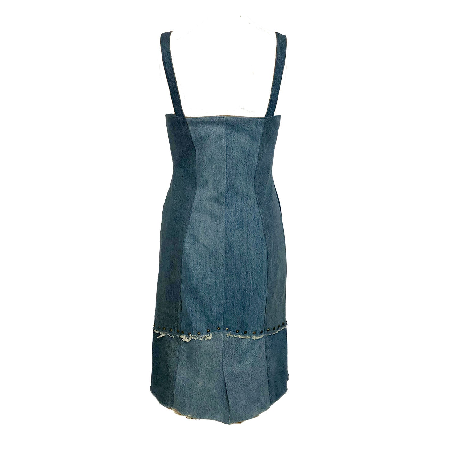 back Two-toned fitted denim sheath dress with front zipper, raw edges, princess seam zippers, and metal studs at hem, made from upcycled cotton denim.