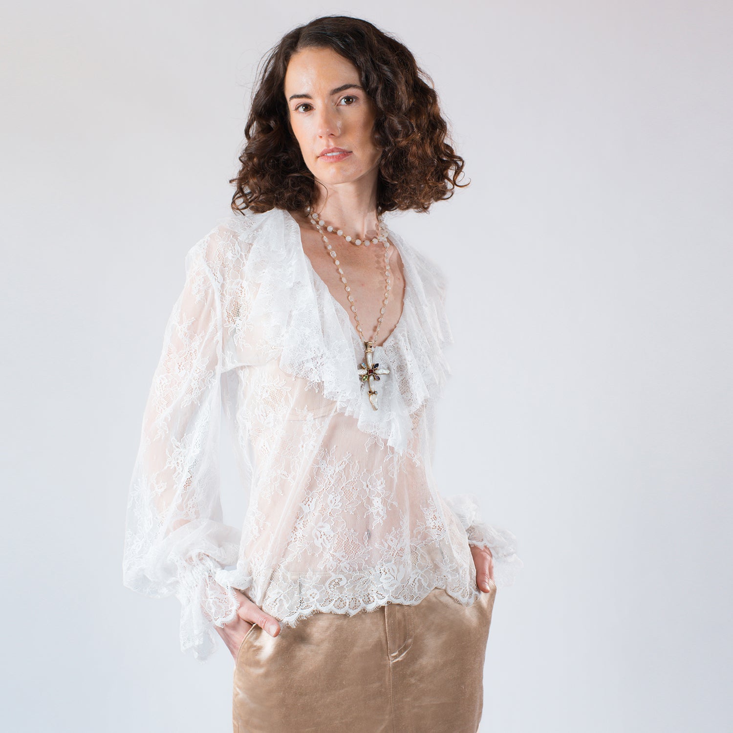 Sheer Chantilly lace blouse with cascading ruffles and voluminous sleeves styled with champagne hemp/silk mini