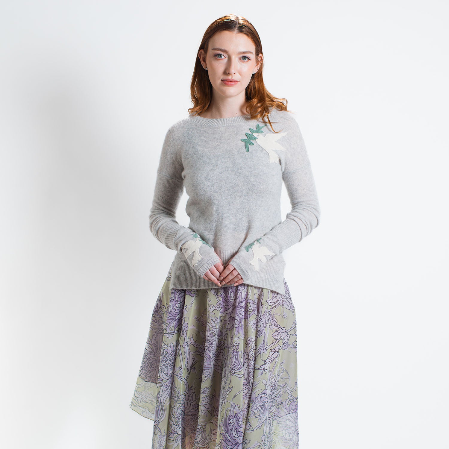 Handmade reincarnated cashmere pullover in heather grey, featuring rhinestone-accented peace dove appliqués. A soft, symbolic, one-of-a-kind sweater.