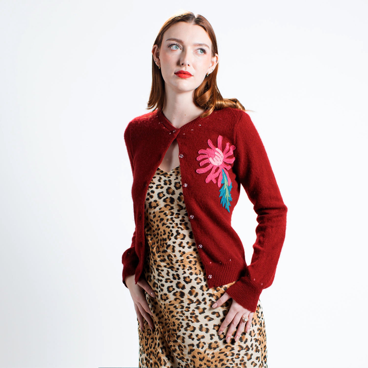 model Chrysanthemum Cardigan in garnet red upcycled cashmere, front view, floral appliqué detail on left chest