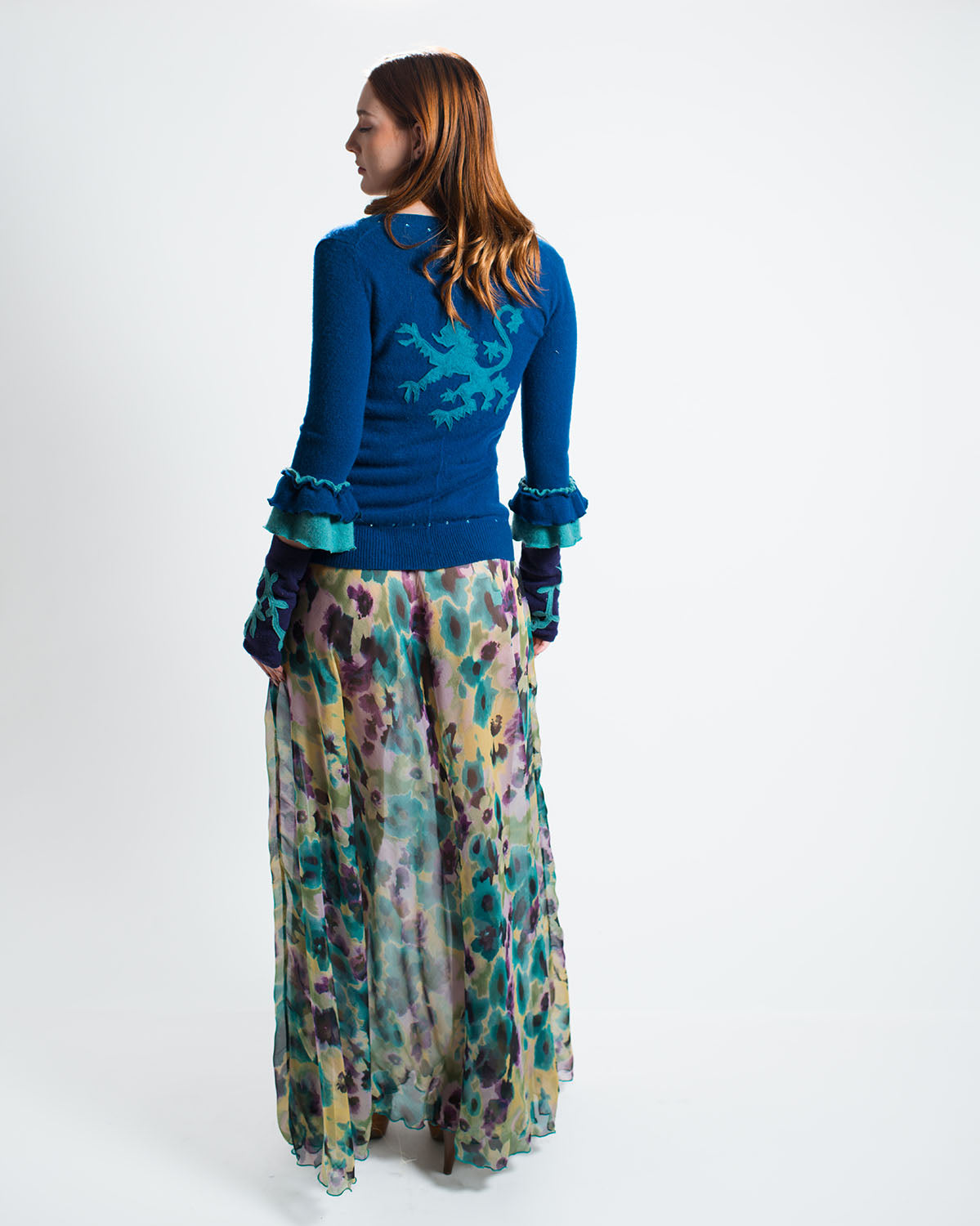 Model in purple cashmere tube top with cardigan, fingerless gloves and floral maxi skirt.