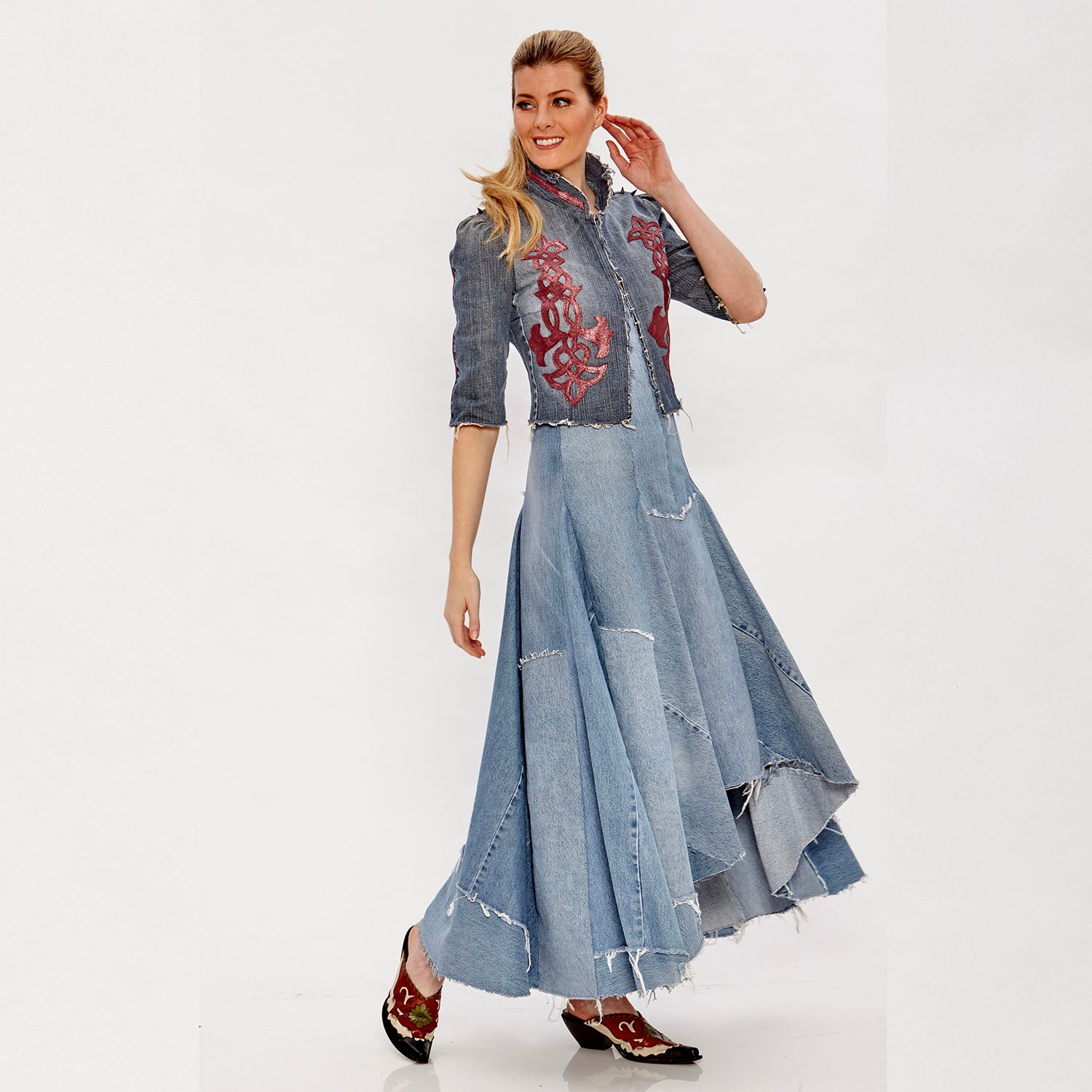 model Gwendolyn Jacket – western-inspired cropped denim jacket with vintage leather appliqué, spike studs, and corset back, shown in dark upcycled wash.