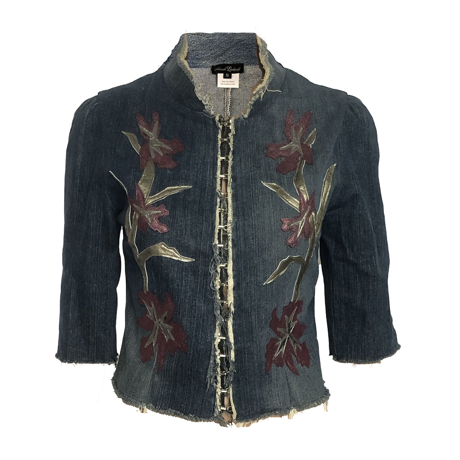 Iris Jacket – upcycled denim jacket with vintage leather floral appliqué, raw hem, and hook closure, shown with gathered elbow-length sleeves.