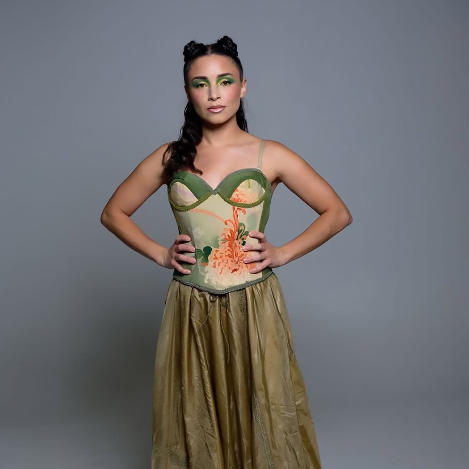 Model wearing a one-of-a-kind vintage kimono silk bustier with jade and coral floral motifs paired with a flowing bronze skirt.