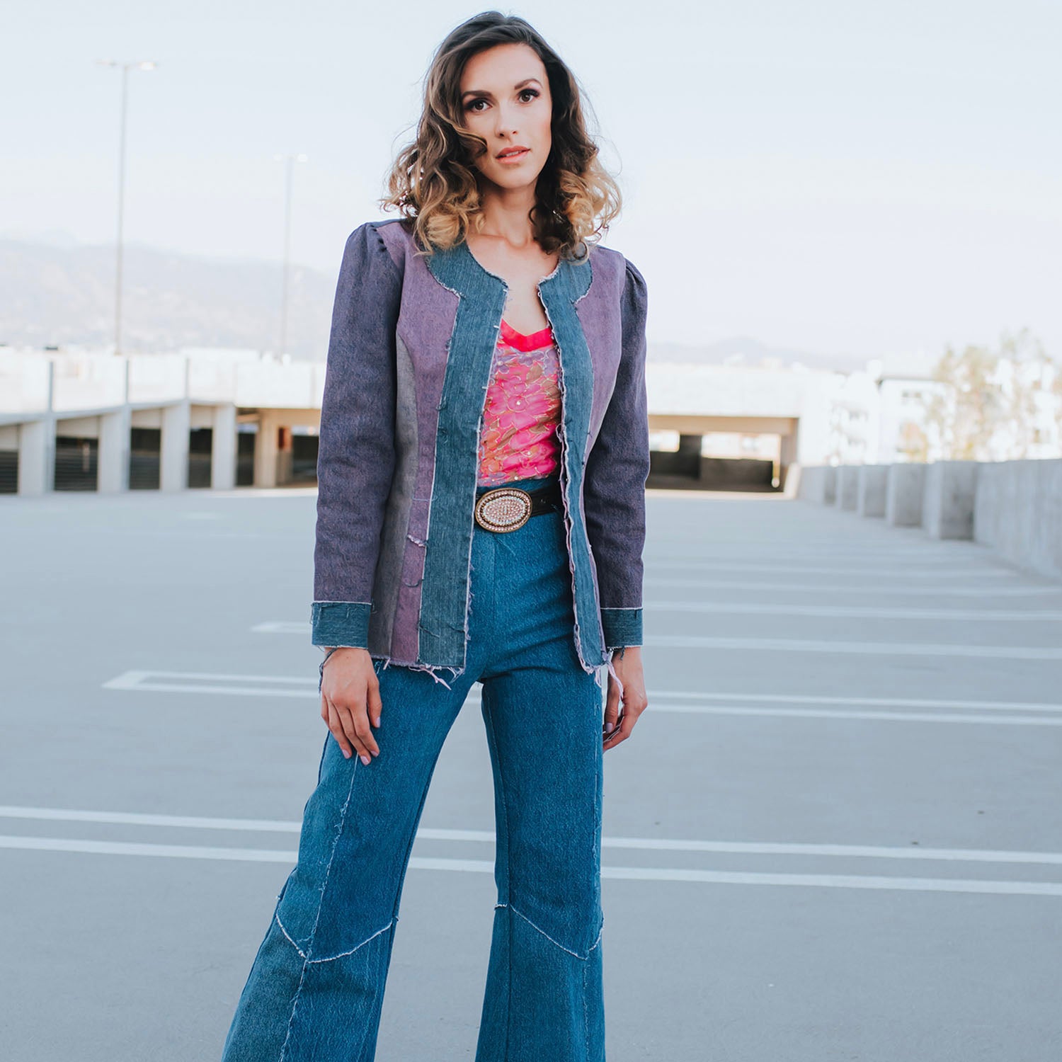 Color-blocked Lana Jacket in overdyed upcycled denim with raw edges, tailored fit, and hook front closure — styled with matching Cher Jeans.