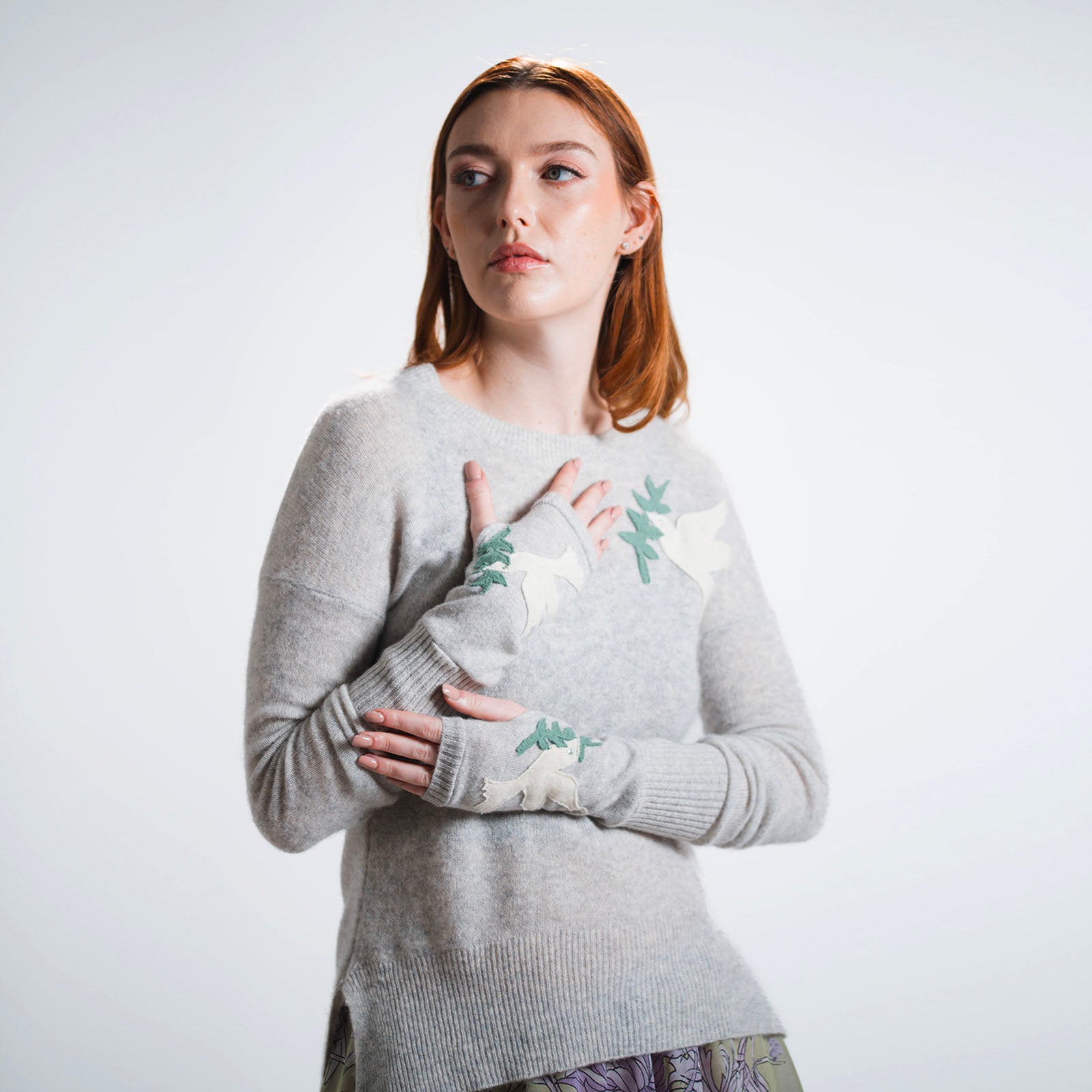 Heather grey cashmere fingerless gloves with ivory dove and green olive branch appliqués on each hand.