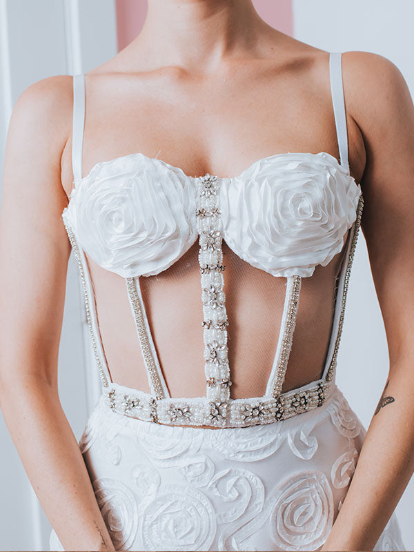 Rosette Bustier – Sheer caged bridal bustier with floral ribbon detailing, pearl and rhinestone embellishment.