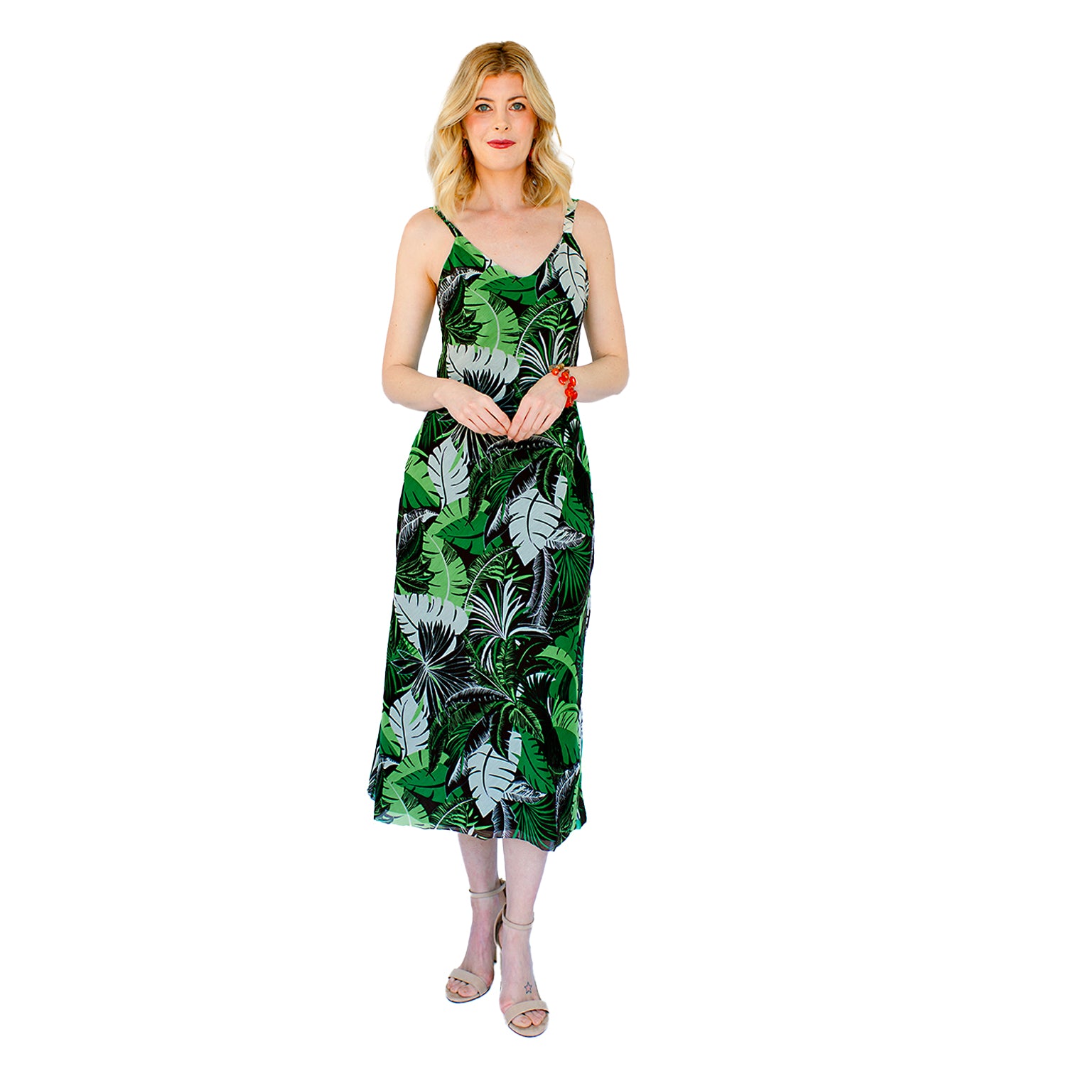 model-Tropical print slip dress with adjustable straps, bias-cut silhouette, and flounced hem, made from silk-cotton deadstock fabric.