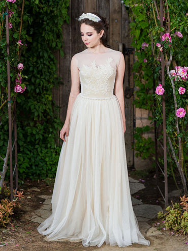 model Beulah Ivory vintage beaded wool bustier with pearl waist detailing, illusion neckline, and English net bow train.