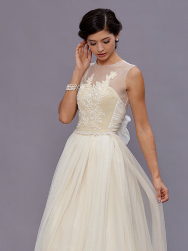 model Beulah Ivory vintage beaded wool bustier with pearl waist detailing, illusion neckline, and English net bow train.