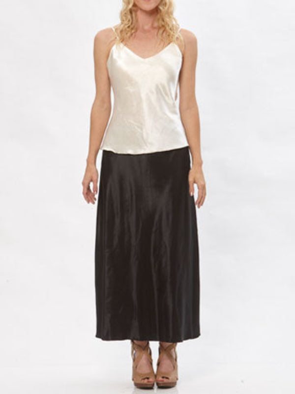Model wearing the Katherine hemp/silk satin bias-cut skirt in black, paired with a cream camisole.