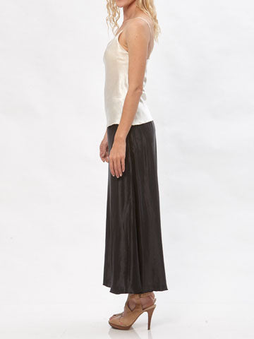 Model wearing the Katherine hemp/silk satin bias-cut skirt in black, paired with a cream camisole.