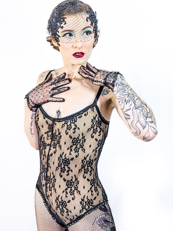 Unlined black lace bodysuit with spaghetti straps, shown layered over nude bodysuit – Vera Lace Bodysuit