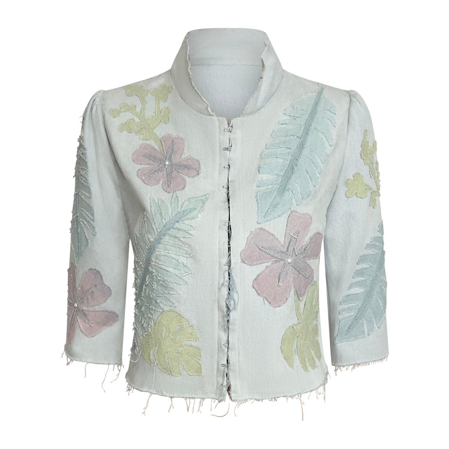 Bleached denim jacket with floral appliqué, hook front, and cropped fit.