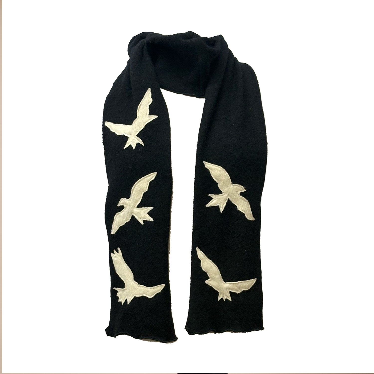 A striking reincarnated cashmere scarf with creme bird appliqués on black