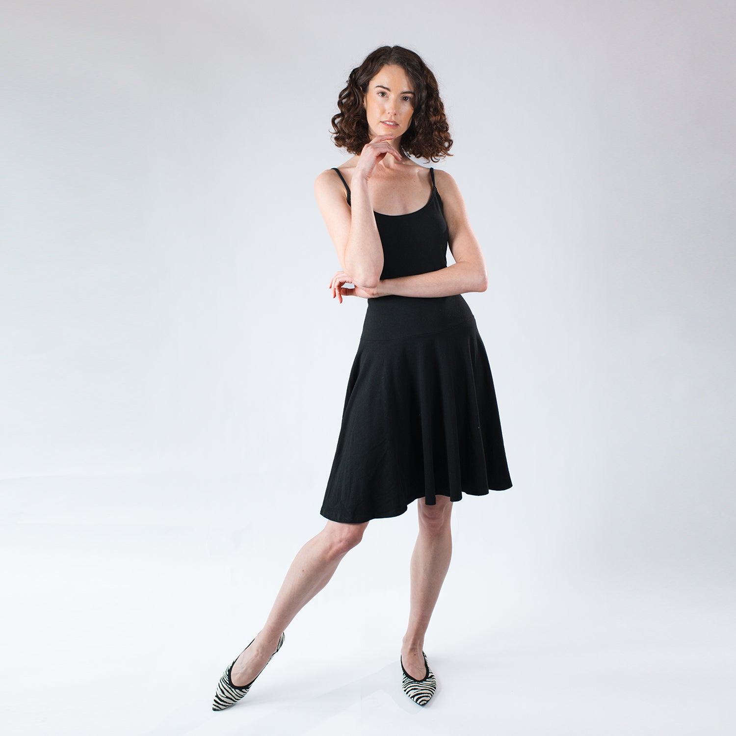 Model wearing a black fit-and-flare dress in hemp and organic cotton jersey.