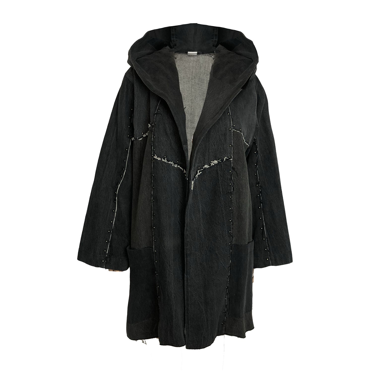 Oversized hooded black denim coat with raw-edge seams and a deconstructed silhouette.