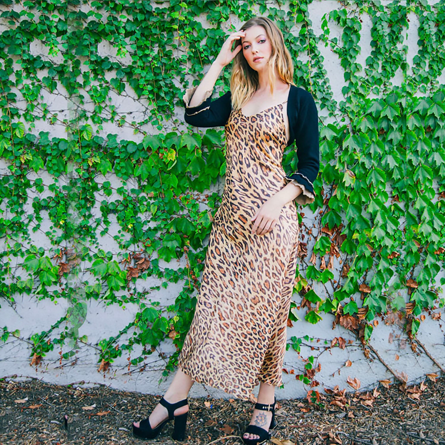 Leopard print silk slip dress with adjustable straps, bias-cut silhouette, and full lining, made from limited deadstock fabric.