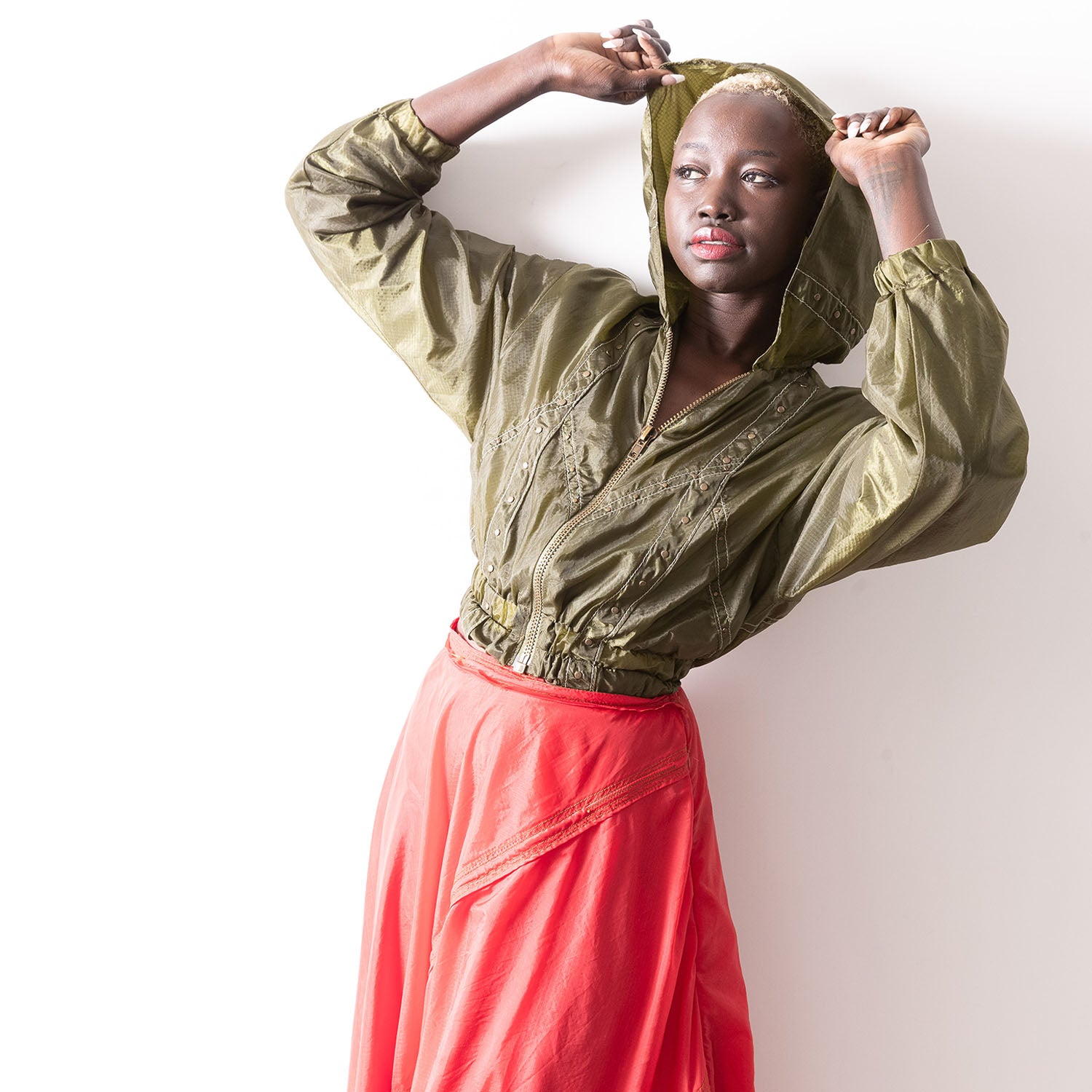 Maxine bomber jacket in upcycled parachute fabric with studs and elastic waist.