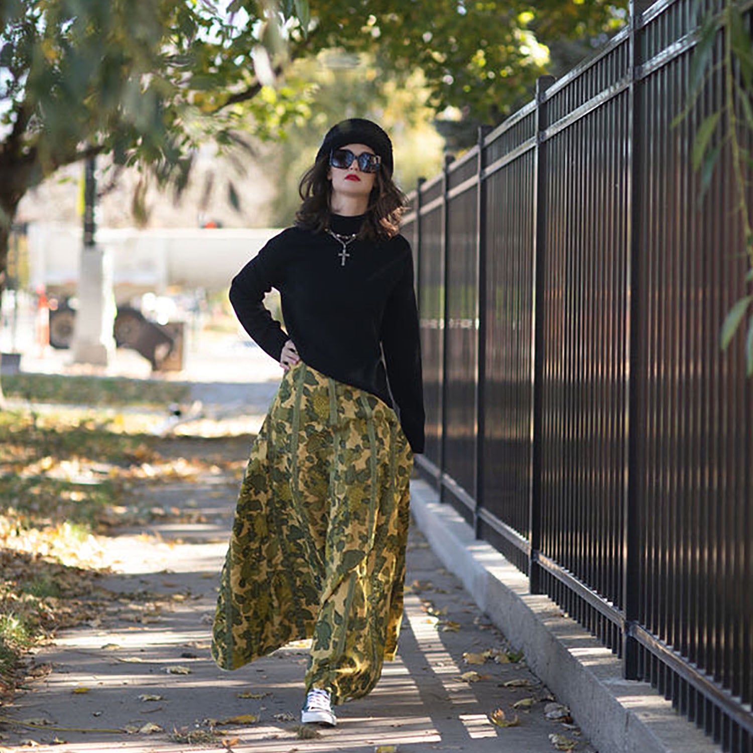 model “Olivia Parachute Skirt in camouflage, gored-panel design with graceful flare, made from upcycled military nylon with original seam variations”