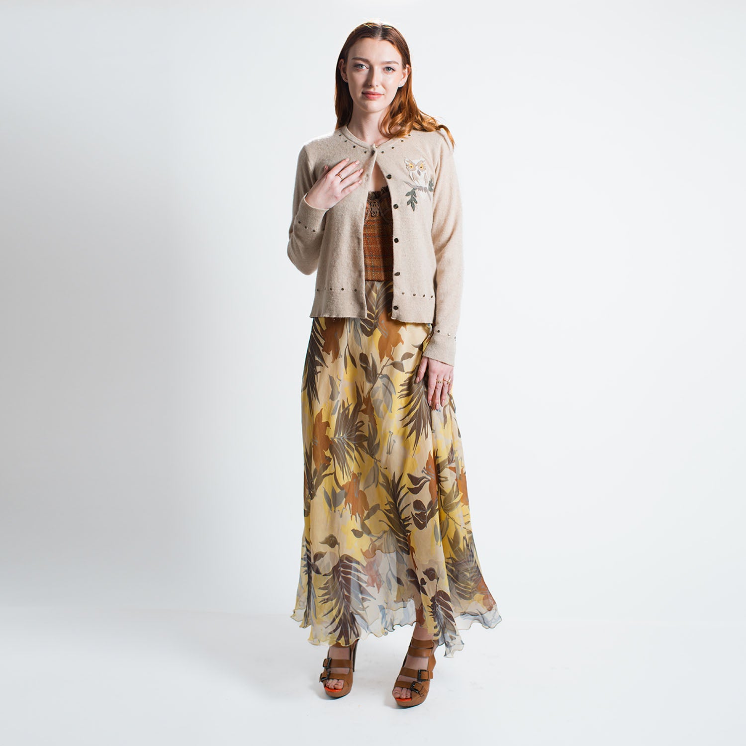 model in Isla Skirt in tropical floral silk chiffon, full-length with flowing silhouette, styled with Owl Cardigan