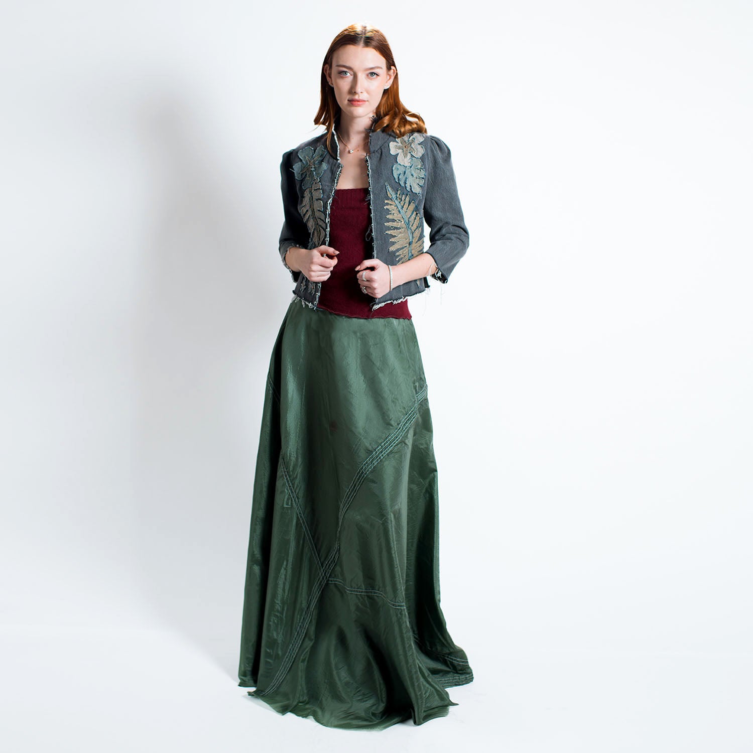 model in Audrey Jacket – cropped upcycled denim jacket with tropical floral appliqué, mandarin collar, and hook-front closure in fitted silhouette.