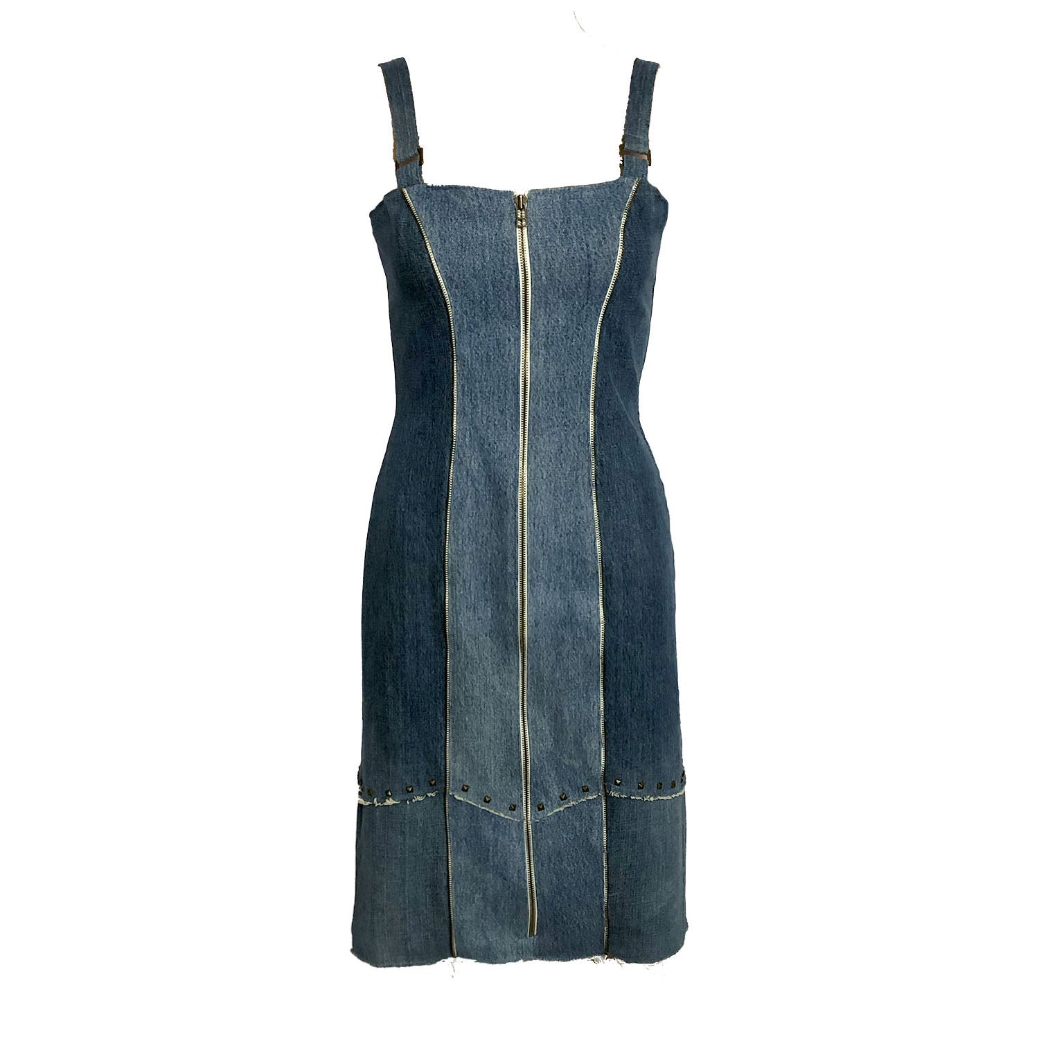 Two-toned fitted denim sheath dress with front zipper, raw edges, princess seam zippers, and metal studs at hem, made from upcycled cotton denim.