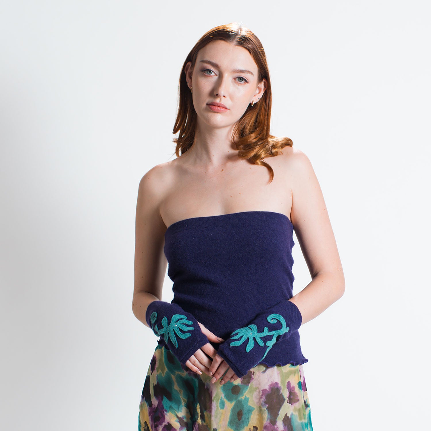 Model in navy cashmere tube top with fingerless gloves and floral maxi skirt.
