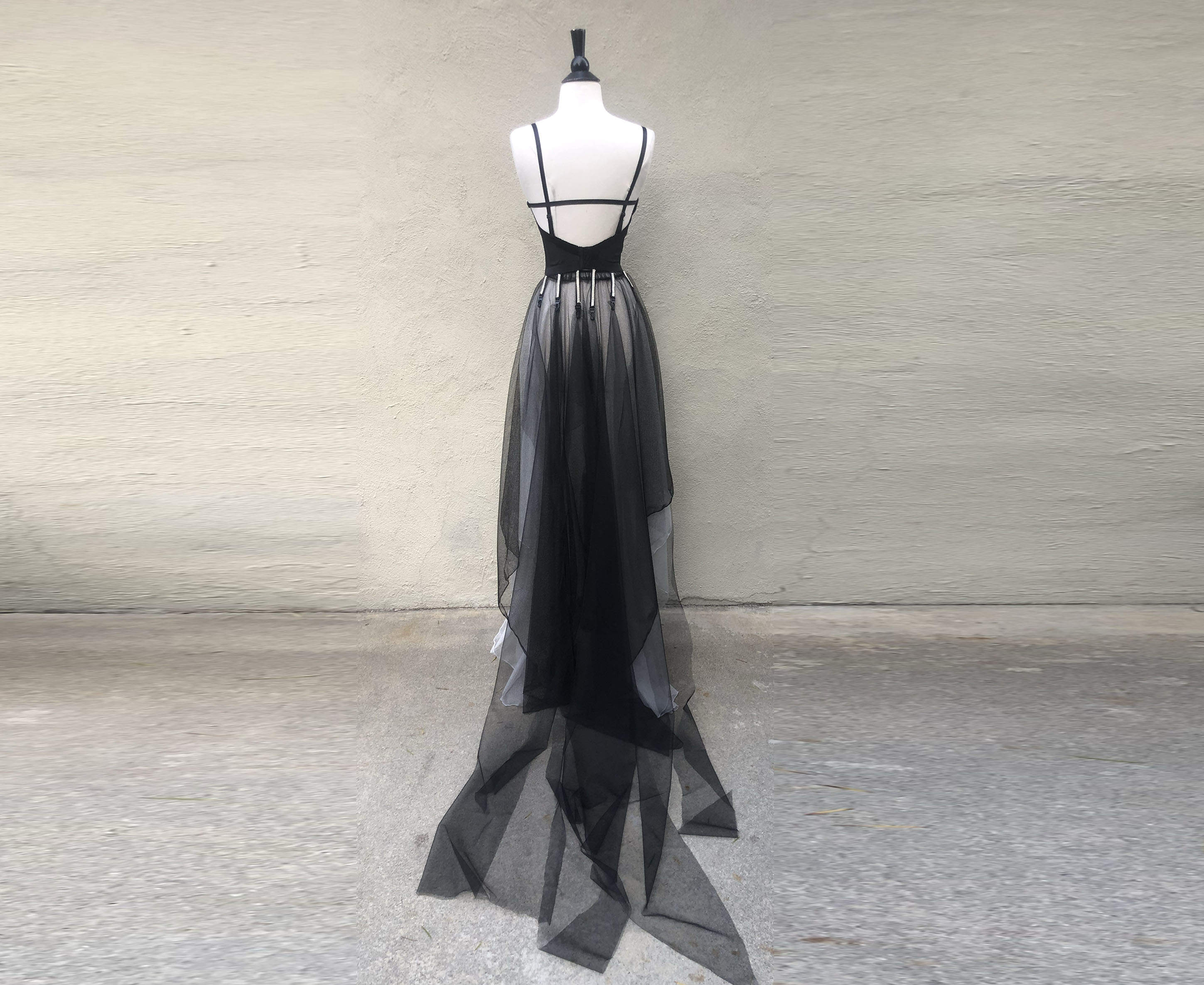 Black lace bustier with rhinestone front detail and detachable black tulle train held by rhinestone garters