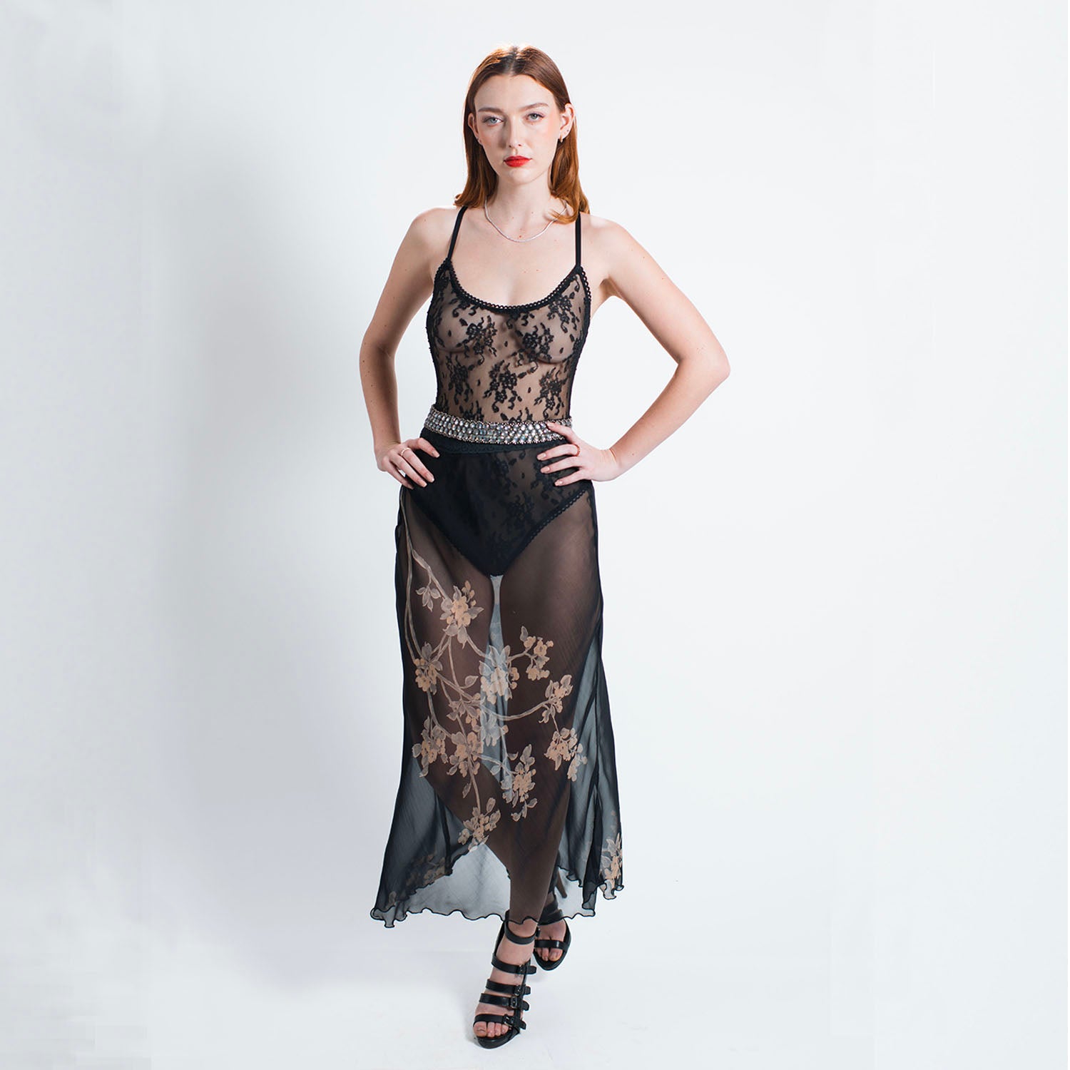 model Sheer black silk chiffon bias-cut skirt with gold floral print and elastic waist, styled unlined for layering over bodysuits. with lace bodysuit