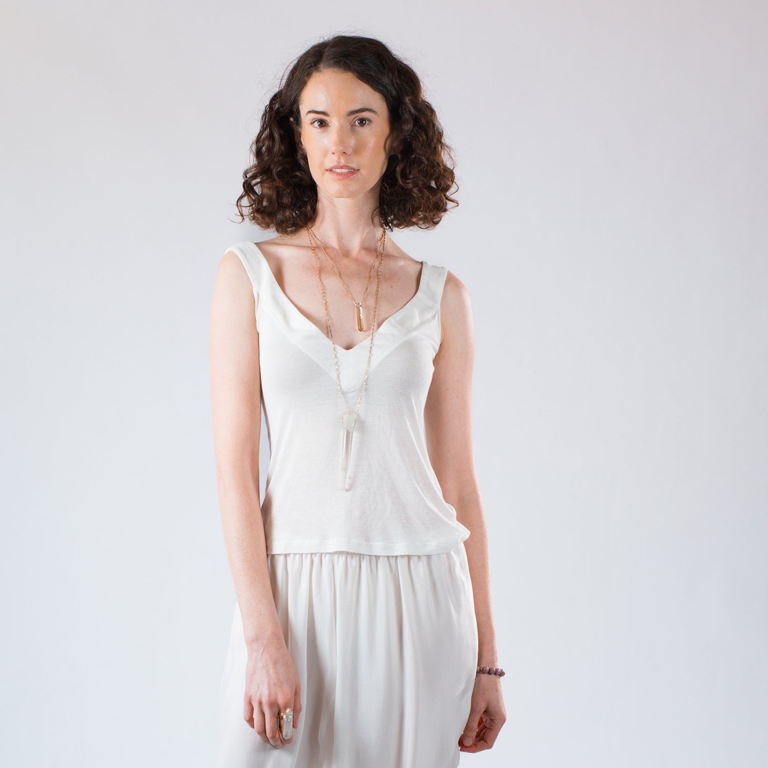 Model wearing an ivory modal tank top with a V neckline.