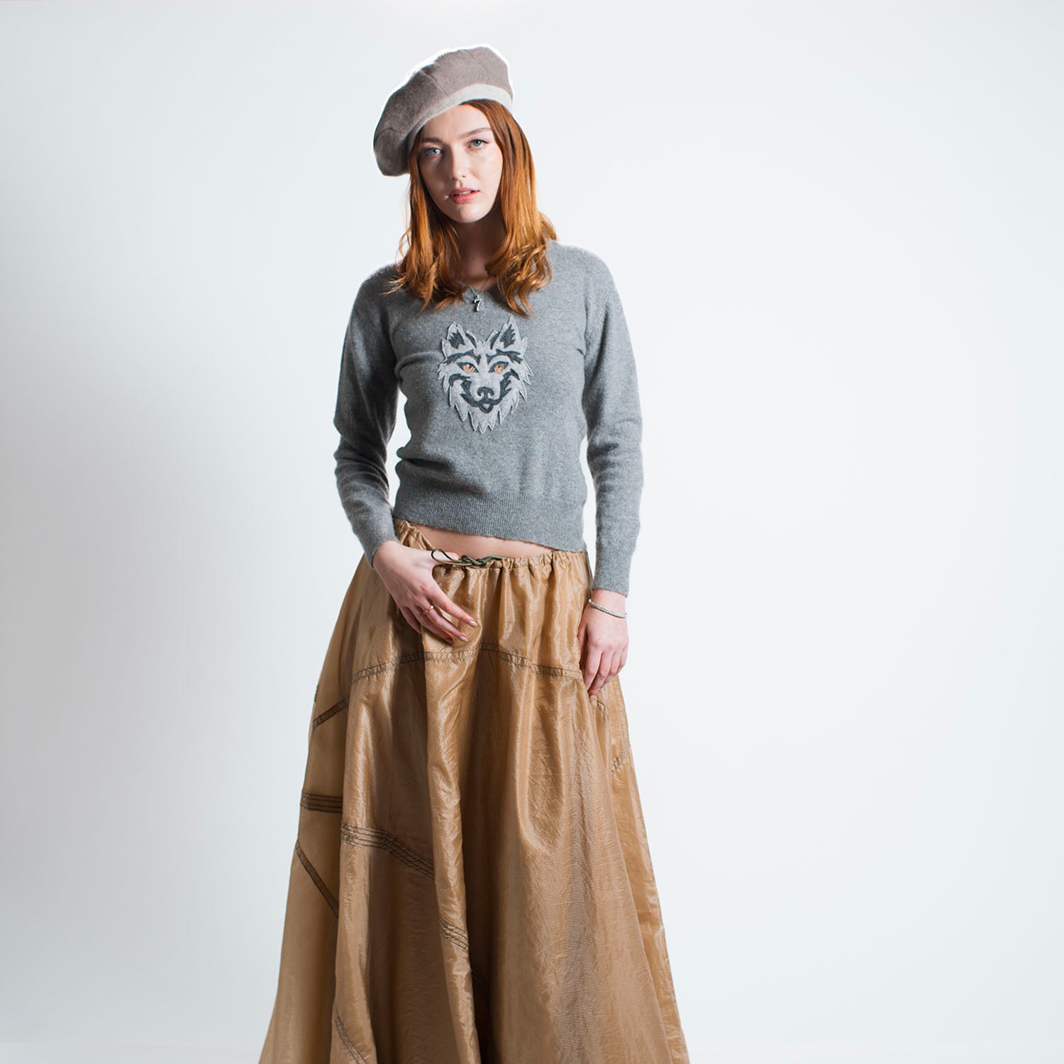 Grey cashmere v-neck pullover with rhinestone-accented wolf appliqué on front.