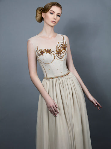 Model in Elysia Gown – one-of-a-kind vintage beaded wool bodice with illusion neckline and bronze floral beadwork, featuring a flowing English net and silk chiffon skirt in soft beige