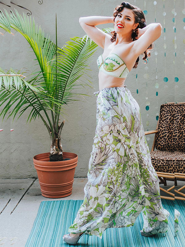 Model wearing the Paloma Wrap Pant in Silk Hibiscus, a flowing wide-leg wrap pant crafted from lightweight deadstock silk with an elegant skirt-like silhouette.